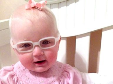 Louise McMorris, 8-month-old baby grins after seeing mom clearly for the first time